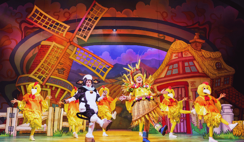 Photo of the stage show showing a windmill and farming fields in the background.